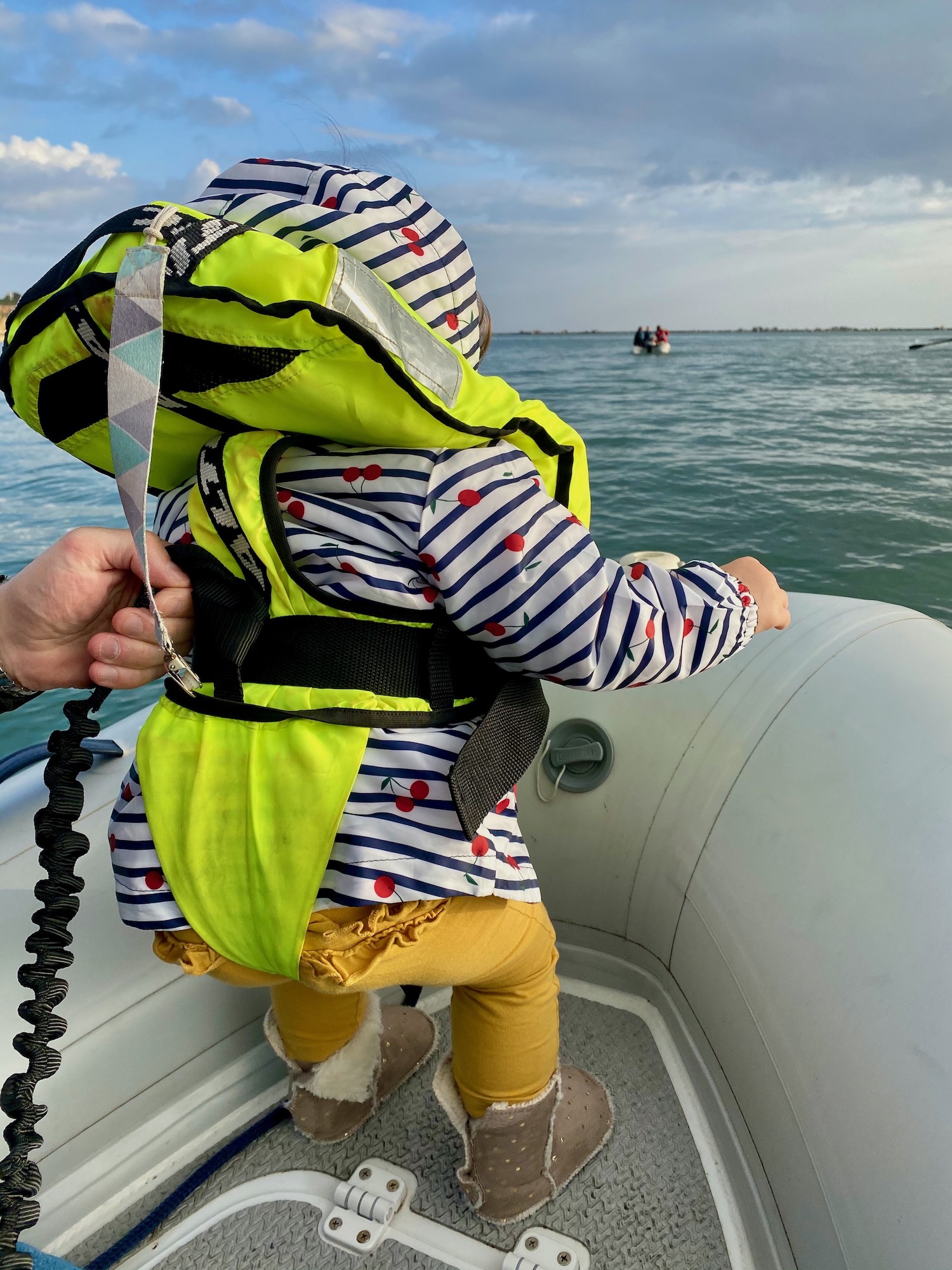 Toddler wearing a Bambi Baltic lifejacket on a sailboat