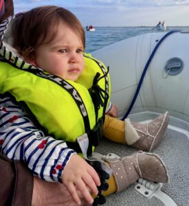Toddler wearing a Bambi Baltic lifejacket on a sailboat